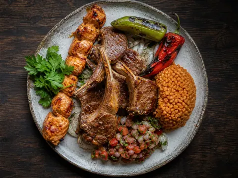 Representative a Turkish mixed grill with lamb chops, chicken shish, grilled peppers, bulgur, and ezme selected for Huqqa Lounge